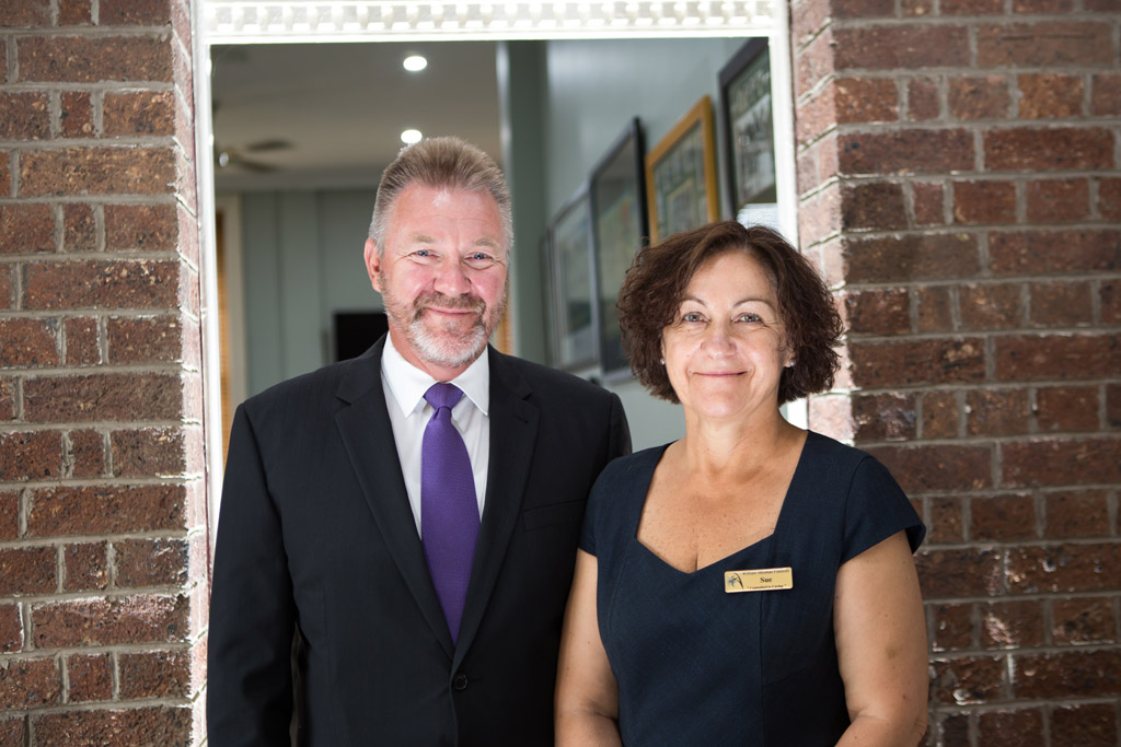 Male and female Drysdale funeral directors standing side by side