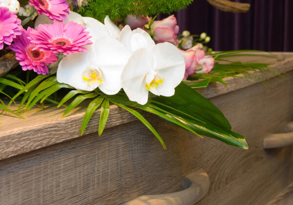 Coffin with flowers at Drysdale funeral parlor