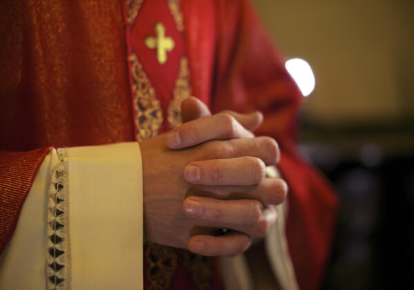 Priest conducting funeral service in Drysdale