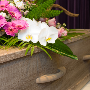 Flowers on top of casket in Drysdale funeral home